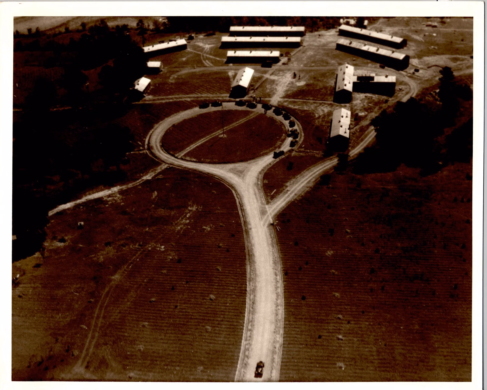 Aerial photograph of a 1930s Civilian Conservation Corps camp with rows of barracks (not Bear Brook)